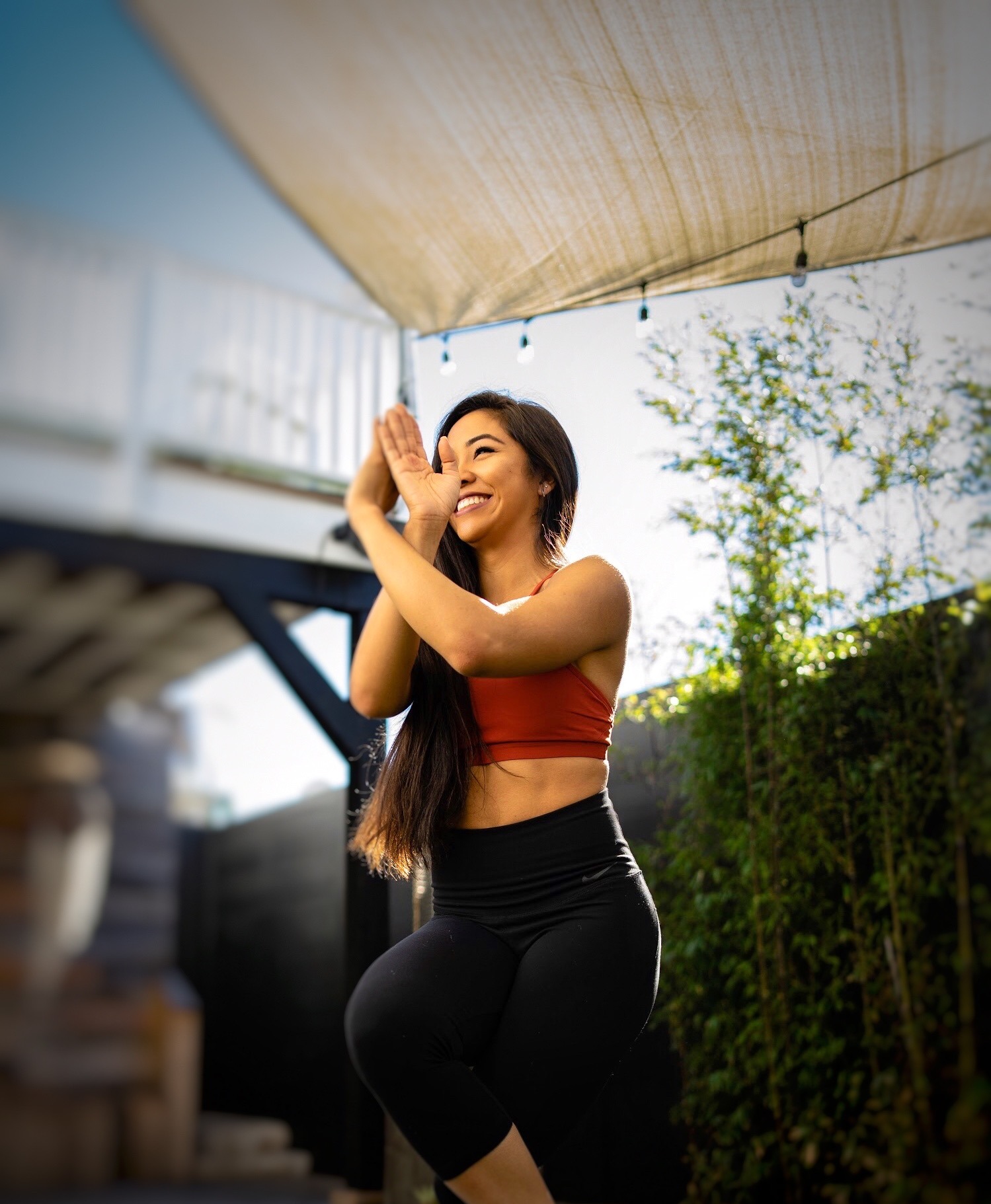 Anika practicing a strength pose in golden light